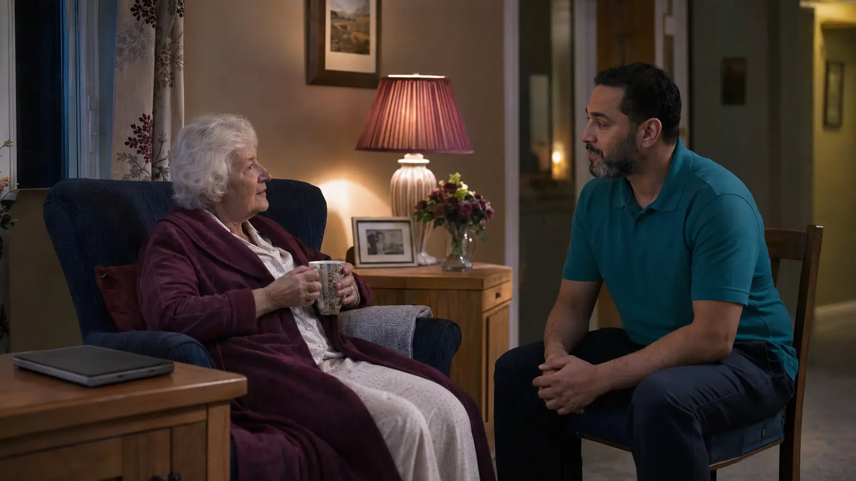 A waking-night care worker providing calm reassurance at home